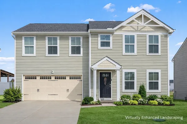 a view of a white house next to a yard