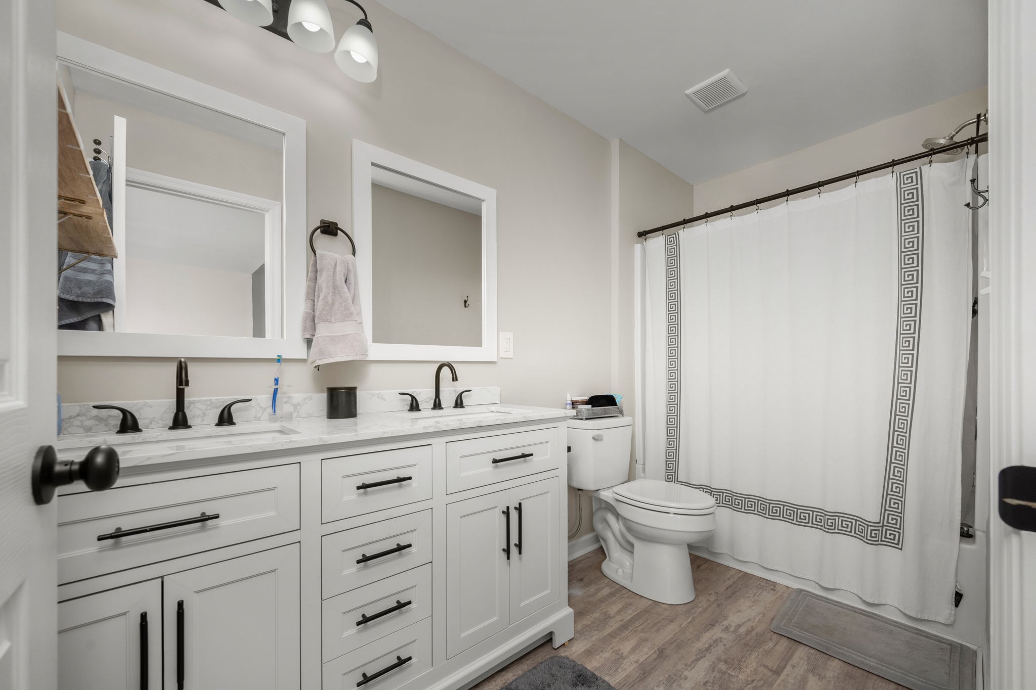 5571 Compass Way Christiana, TN 37037 - Photo 11 of 23 a bathroom with a double vanity sink toilet mirror and shower