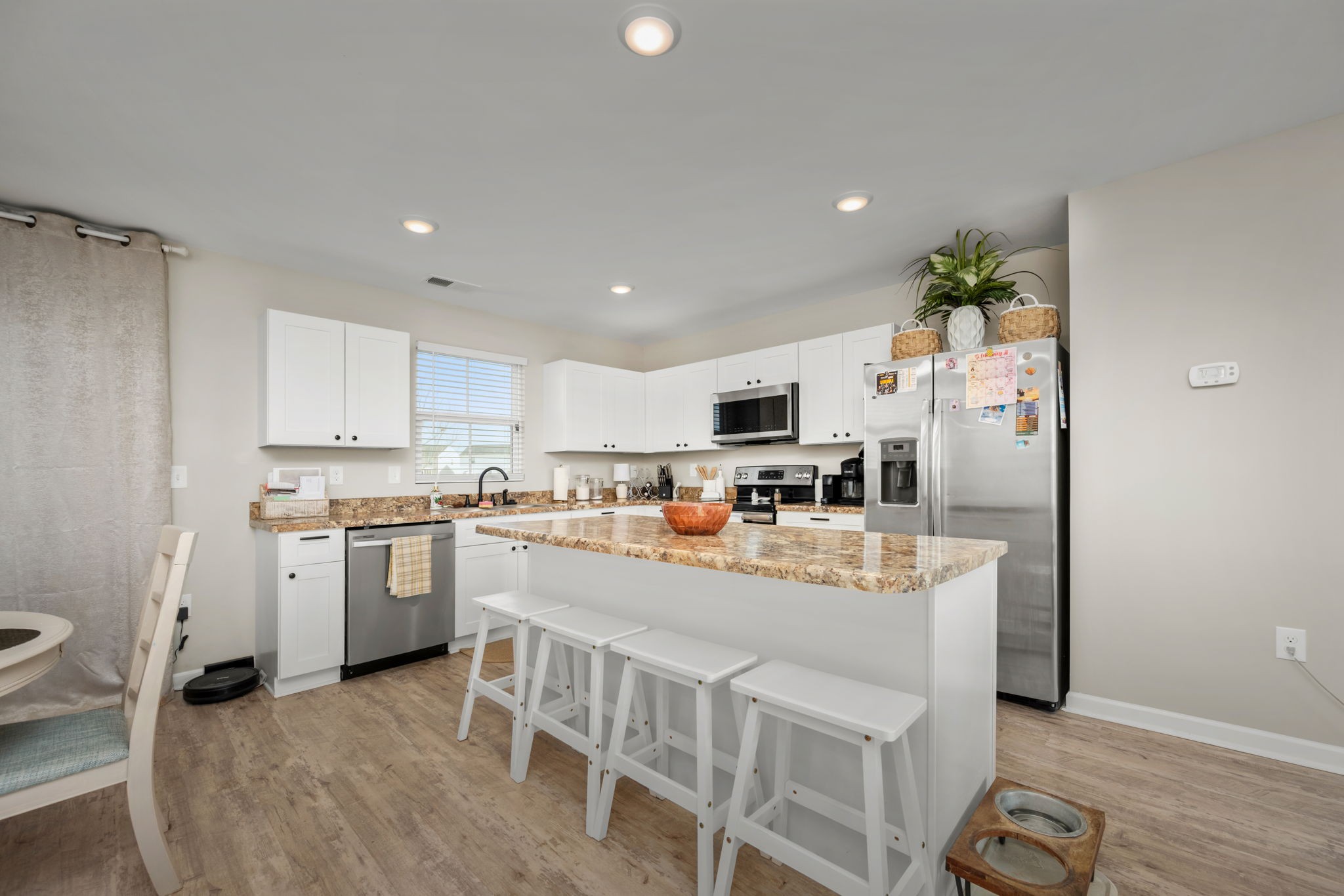 5571 Compass Way Christiana, TN 37037 - Photo 6 of 23 a open kitchen with stainless steel appliances granite countertop a refrigerator a stove top oven a sink dishwasher and white cabinets with wooden floor