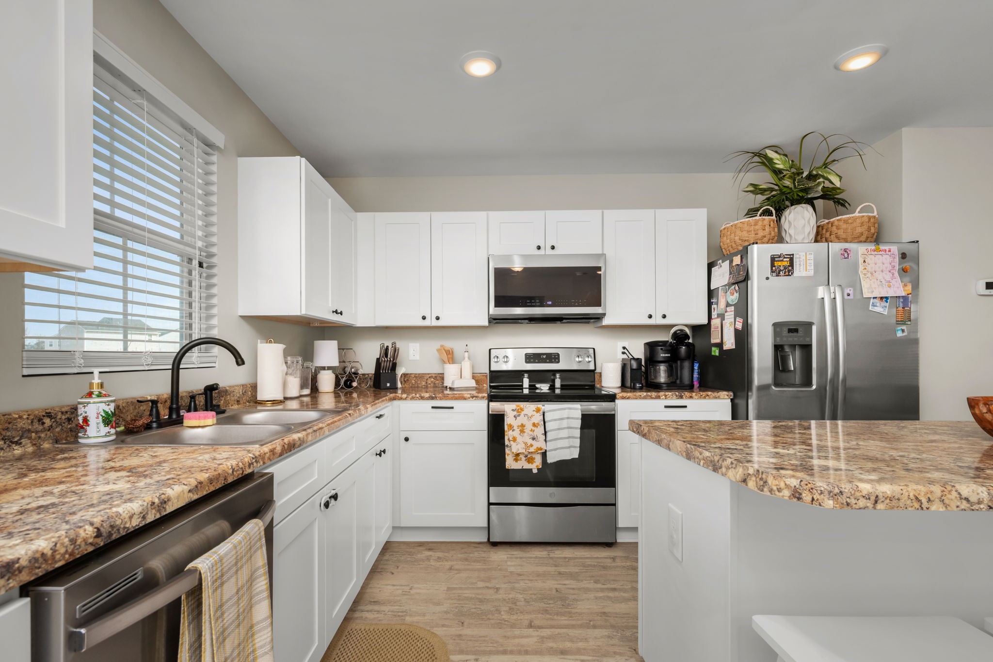 5571 Compass Way Christiana, TN 37037 - Photo 7 of 23 a kitchen with stainless steel appliances granite countertop a sink a stove top oven a refrigerator and dishwasher with wooden floor