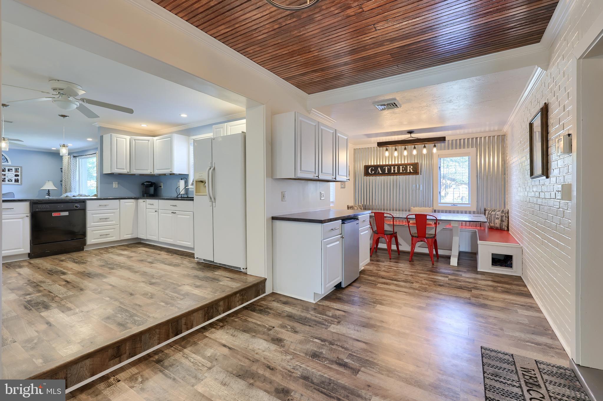 304 Edgehill Road York, PA 17403 - Photo 17 of 44 a kitchen with stainless steel appliances granite countertop a refrigerator oven a sink dishwasher and white cabinets with wooden floor