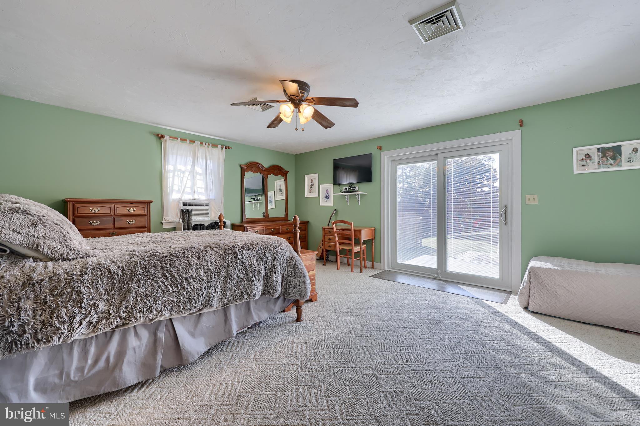 304 Edgehill Road York, PA 17403 - Photo 23 of 44 a spacious bedroom with a balcony a bed and a chandelier