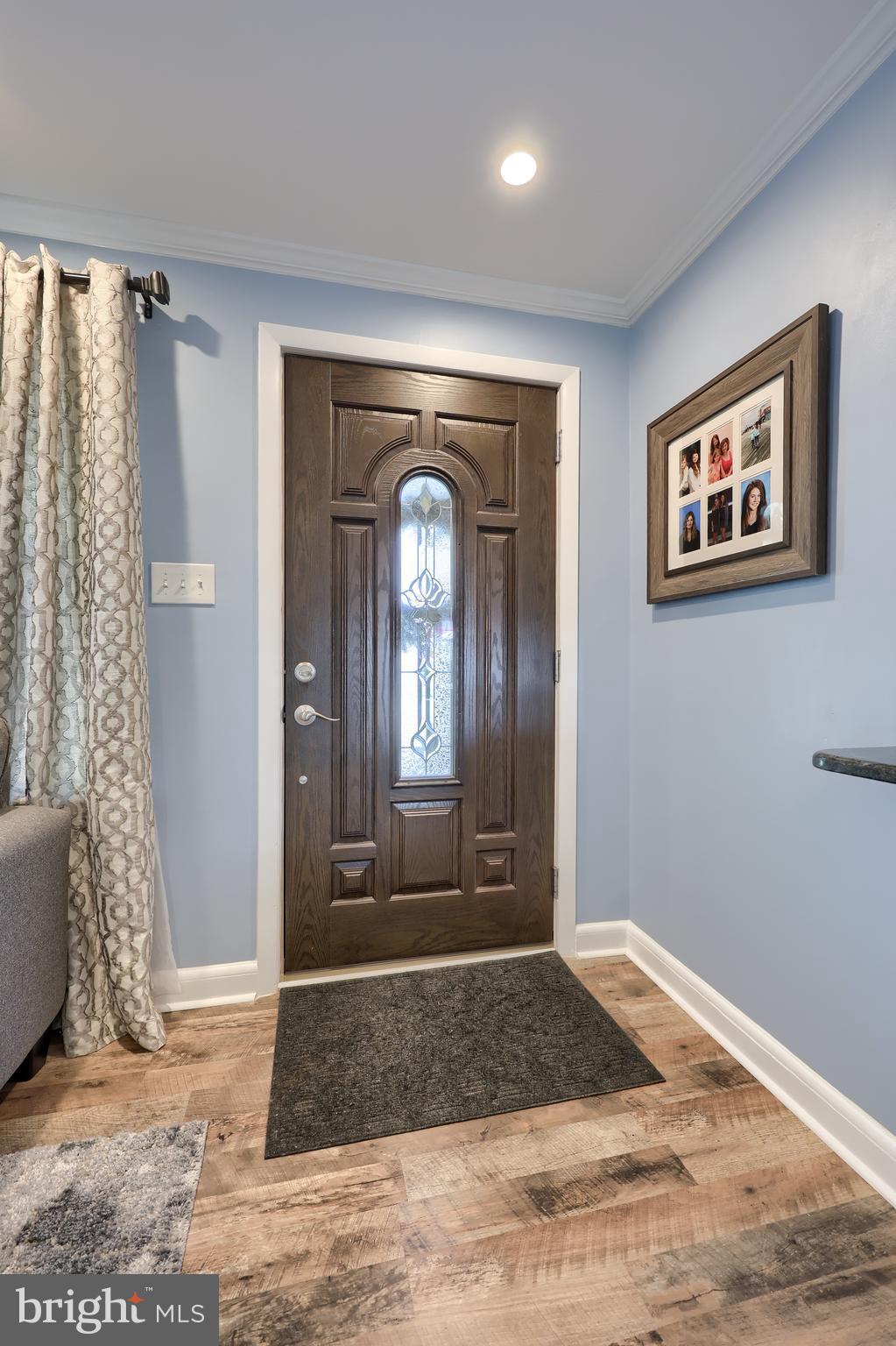 304 Edgehill Road York, PA 17403 - Photo 4 of 44 a view of a hallway with entryway windows and wooden floor