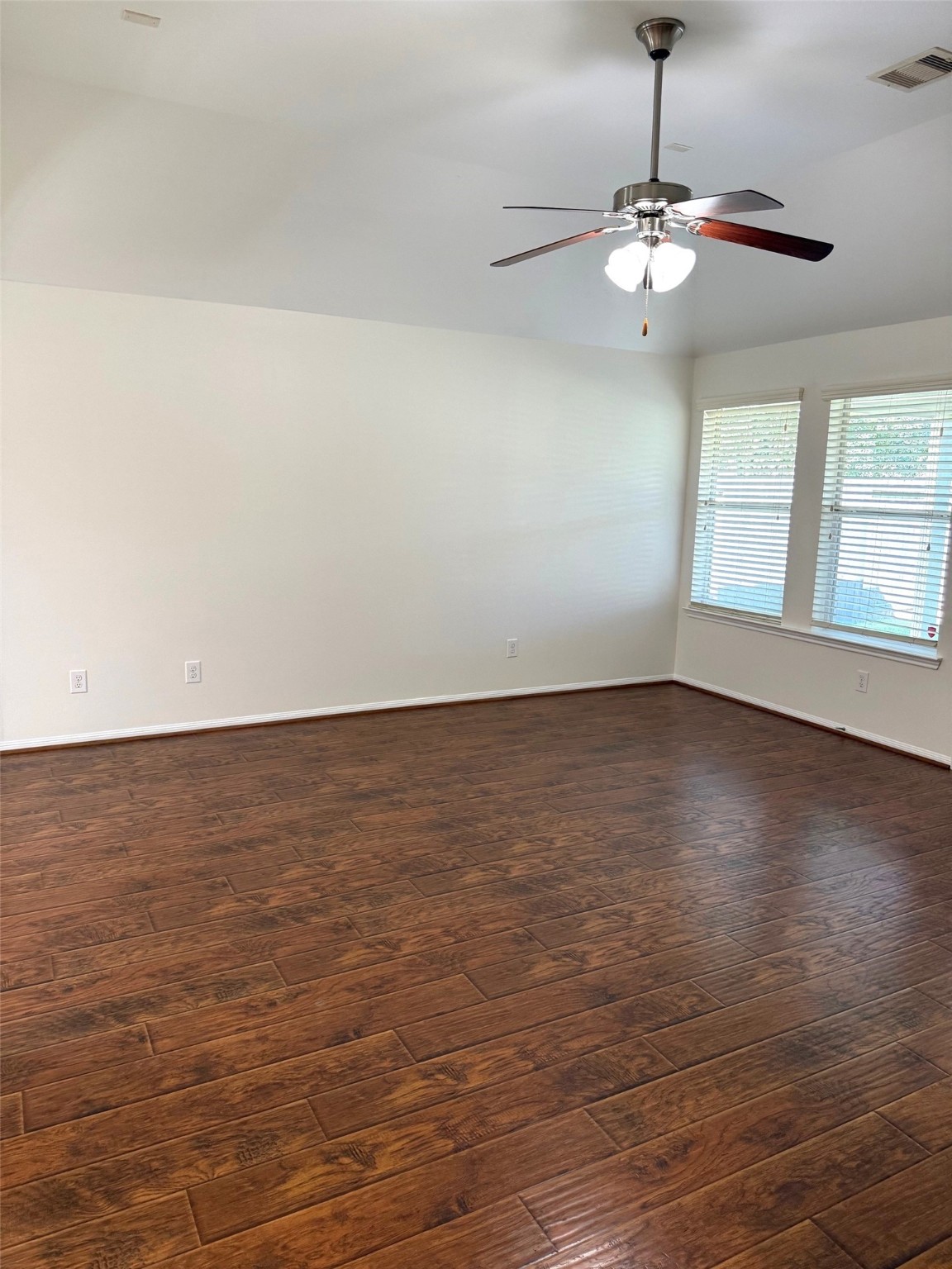 16818 Ranger Ridge Drive Cypress, TX 77429 - Photo 11 of 31 an empty room with wooden floor and windows