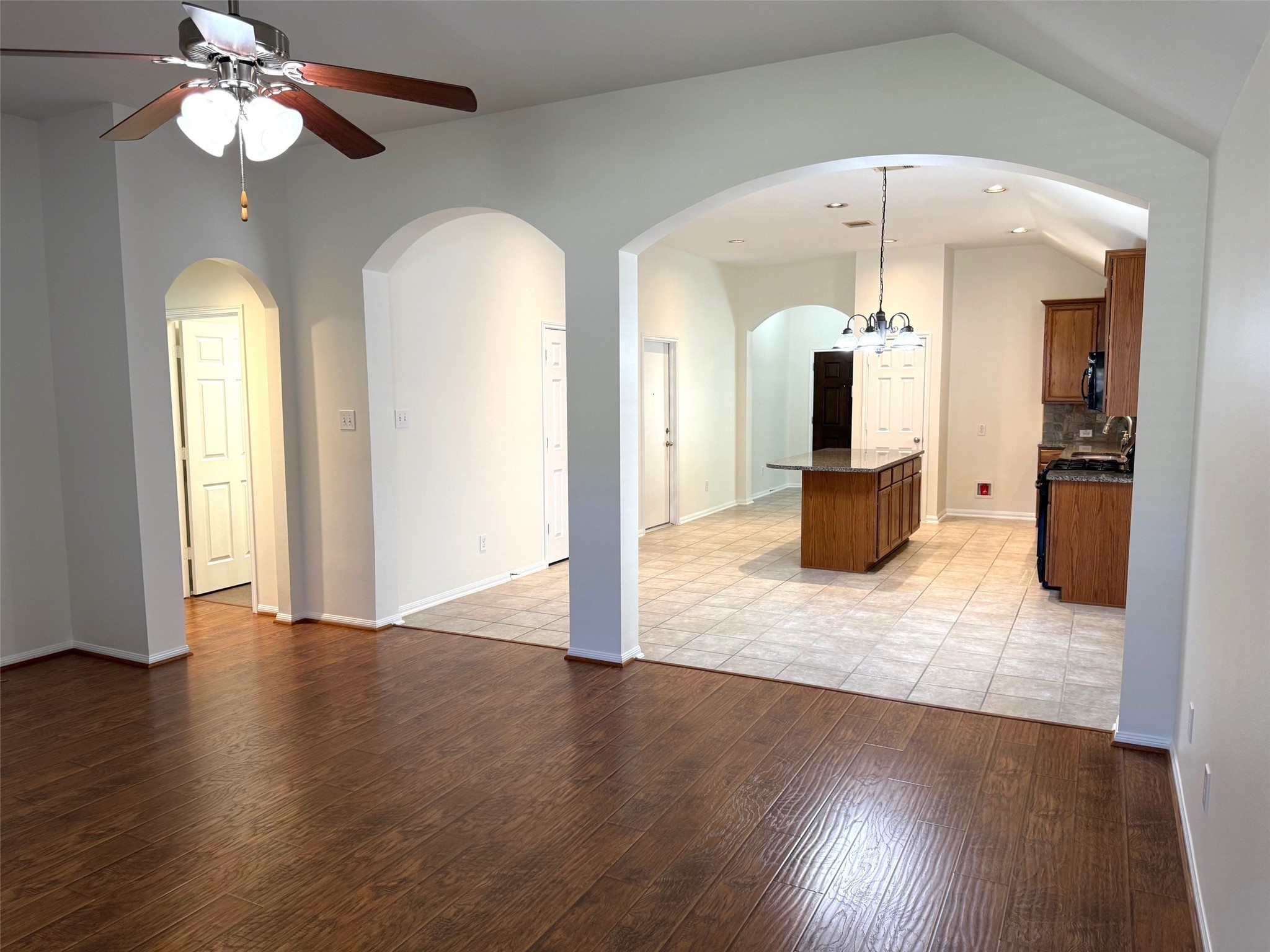 16818 Ranger Ridge Drive Cypress, TX 77429 - Photo 14 of 31 an empty room with wooden floor chandelier and glass door