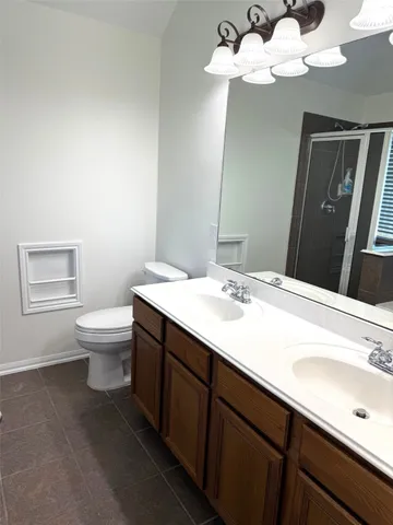 a bathroom with a sink a toilet and a mirror