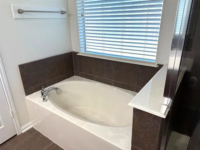 a bathroom with a bathtub and a sink