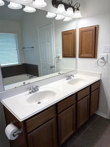 a bathroom with a sink vanity and a mirror