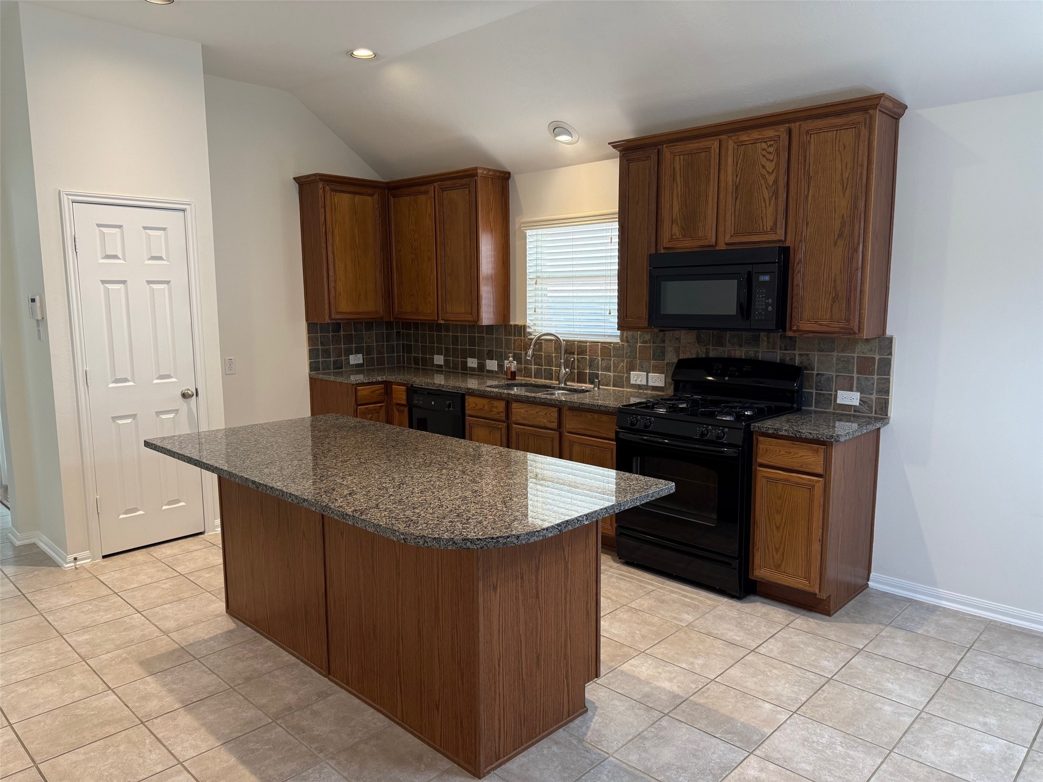 16818 Ranger Ridge Drive Cypress, TX 77429 - Photo 5 of 31 a kitchen with stainless steel appliances granite countertop a stove a sink and a microwave
