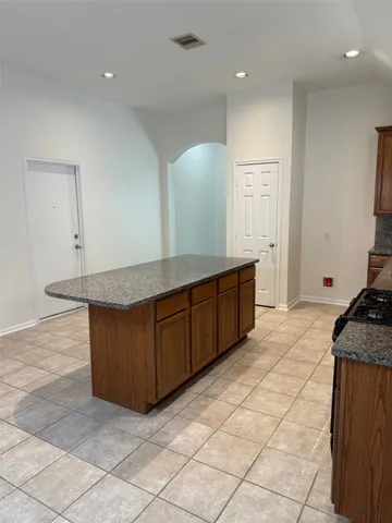 a kitchen with granite countertop a sink and a stove