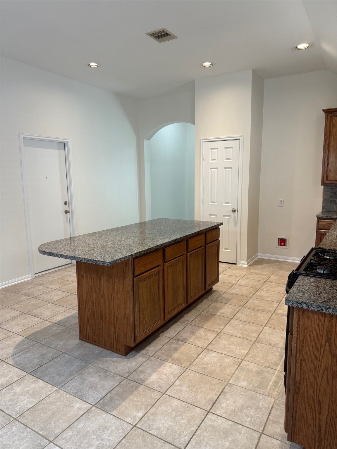16818 Ranger Ridge Drive Cypress, TX 77429 - Photo 6 of 31 a kitchen with granite countertop a sink and a stove
