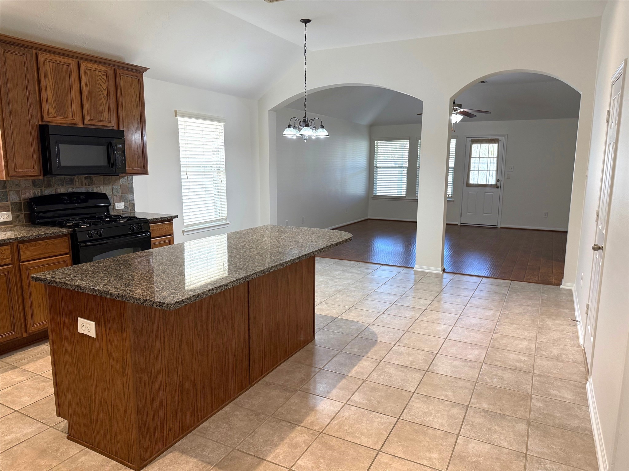 16818 Ranger Ridge Drive Cypress, TX 77429 - Photo 9 of 31 a kitchen with granite countertop a stove a sink and a refrigerator