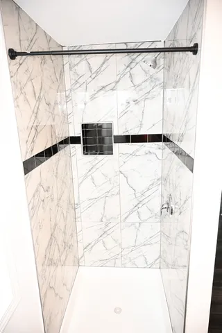 a bathroom with a bathtub and shower