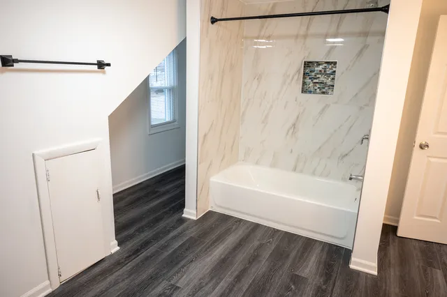 a bathroom with a bathtub and a shower