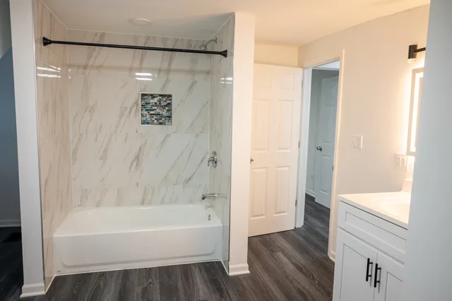 a bathroom with a bathtub and a shower