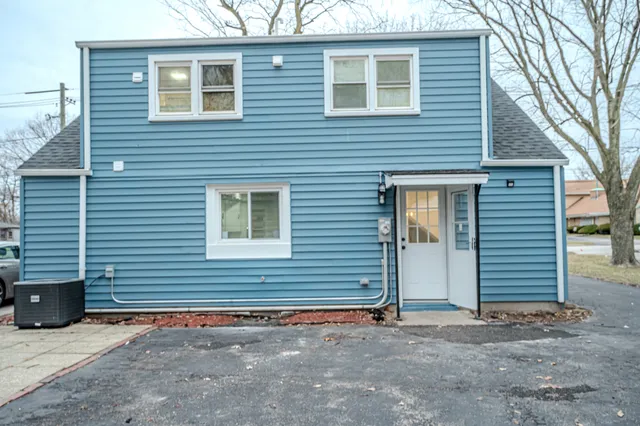 a view of a house with a yard and garage
