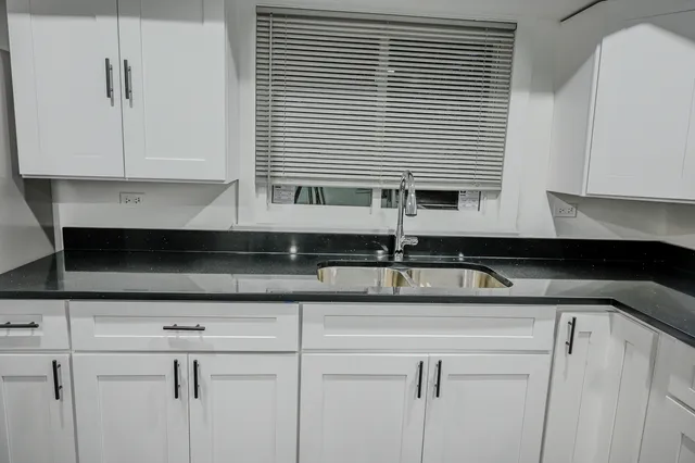 a kitchen with a sink and cabinets
