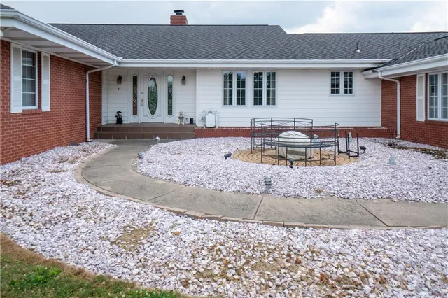 a front view of a house with a garden