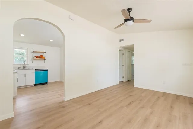 a view of a kitchen with a sink and wooden floor