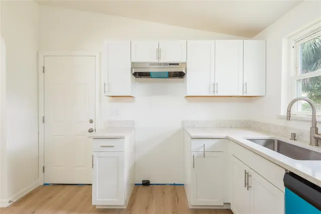 a kitchen with a sink cabinets and appliances