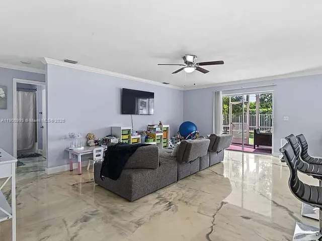 a living room with furniture and a ceiling fan
