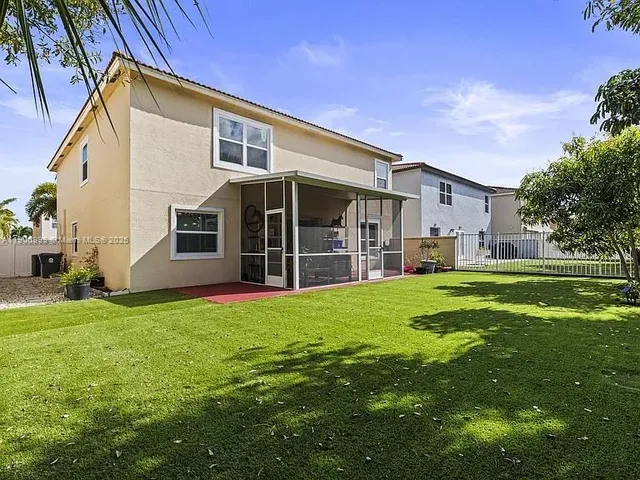 a view of a house with backyard and porch