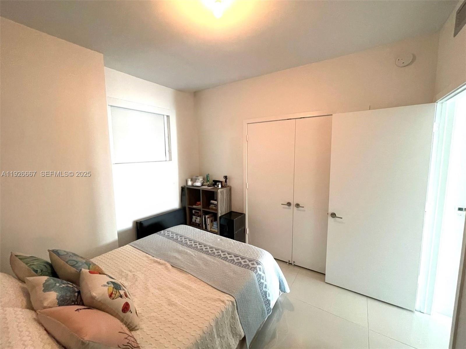 2900 Northeast 7th Avenue, Unit 2006 Miami, FL 33137 - Photo 11 of 16 a bedroom with a bed and a window