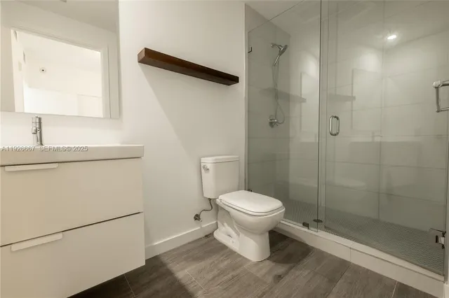 a bathroom with a toilet a sink and shower