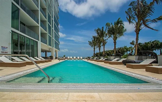 a view of a backyard with swimming pool