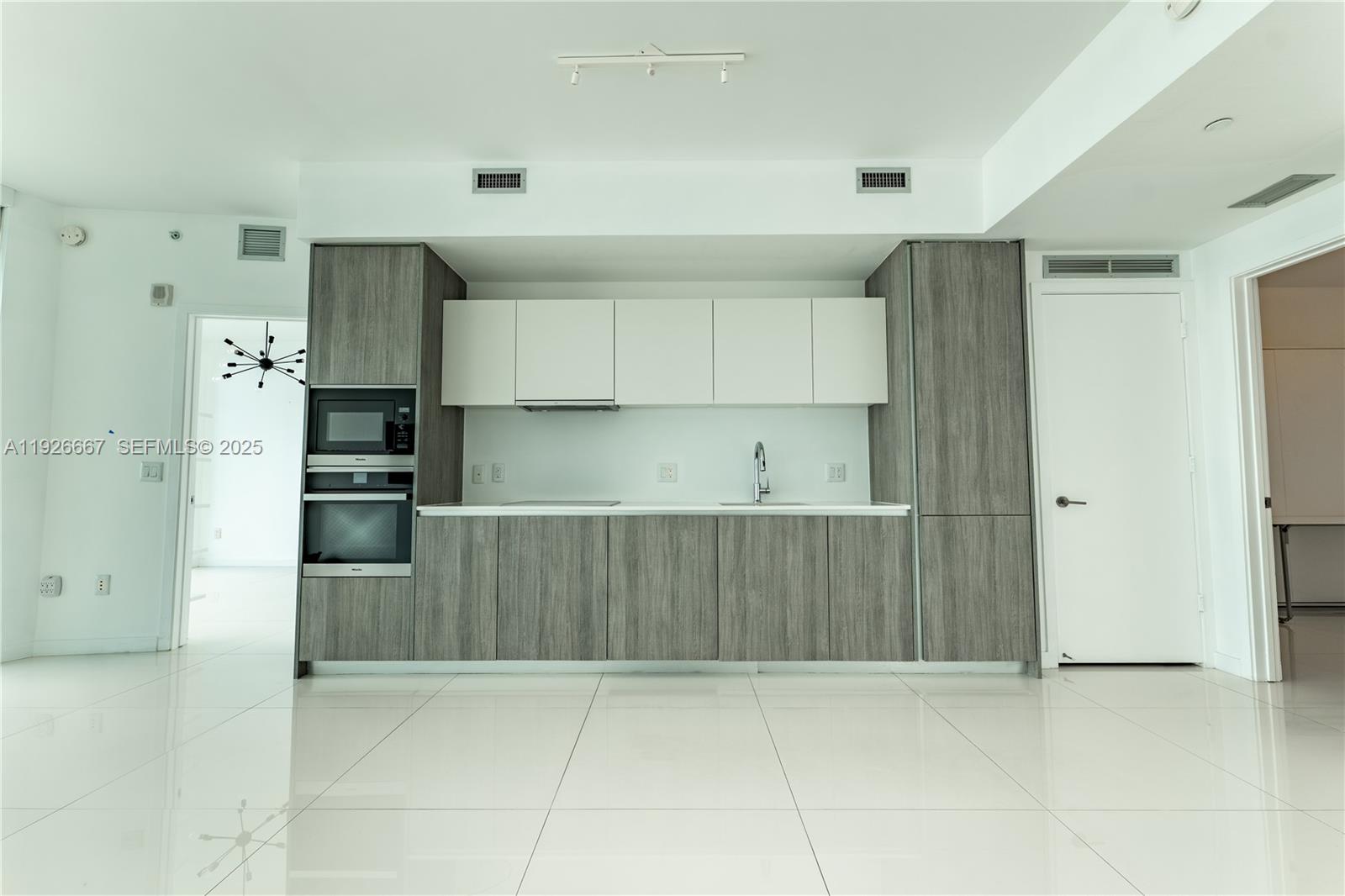 2900 Northeast 7th Avenue, Unit 2006 Miami, FL 33137 - Photo 3 of 16 a kitchen with stainless steel appliances a refrigerator and a stove top oven