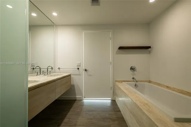 a bathroom with a bathtub and a sink
