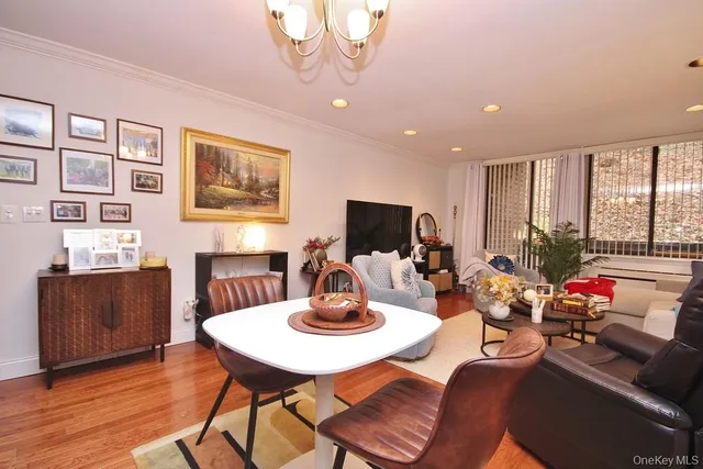 a living room with furniture a flat screen tv and a large window