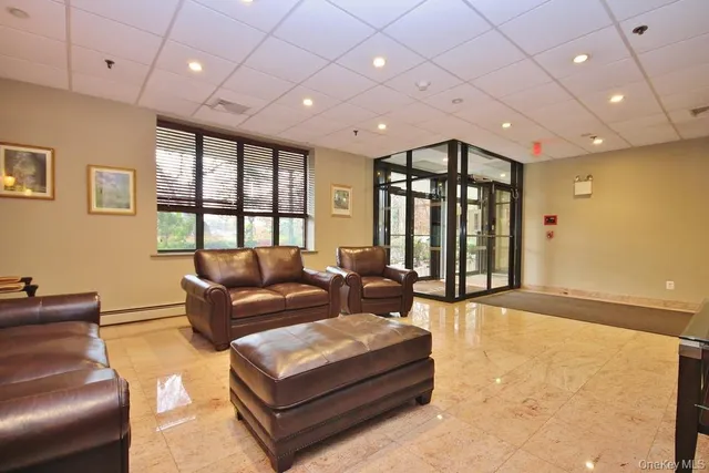 a living room with furniture and large windows
