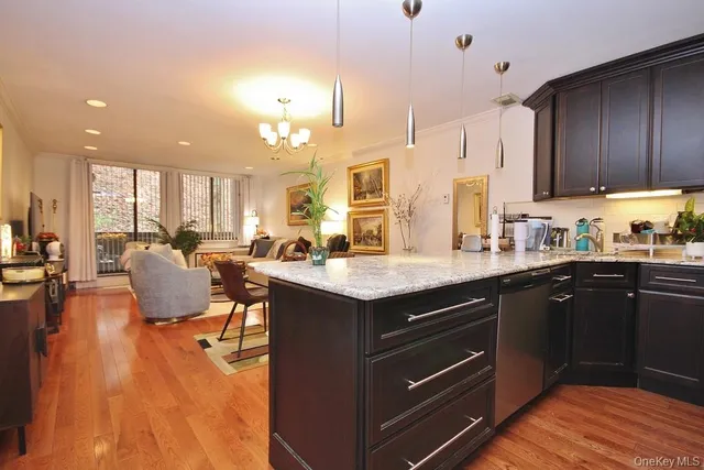 a kitchen with a sink cabinets and wooden floor