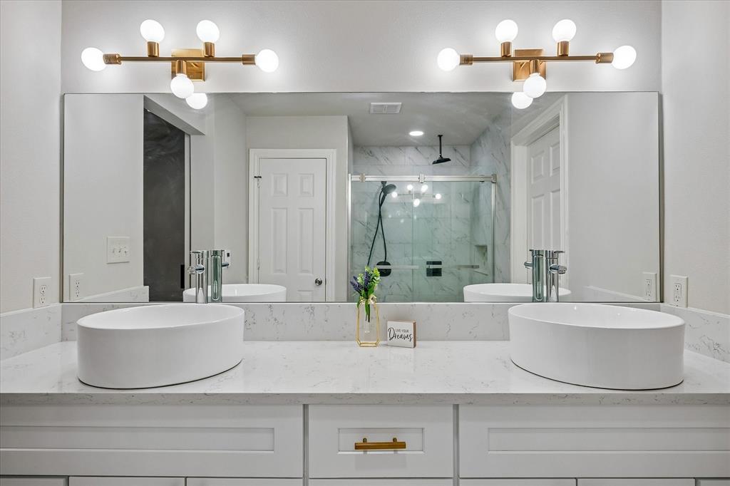 2001 Pebblebrook Trail Irving, TX 75060 - Photo 18 of 40 Dual Sinks in the Primary Bath with new cabinets.