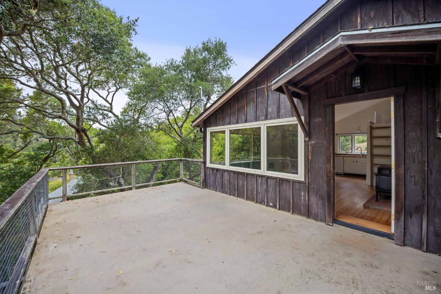 24 Cameron Street Inverness, CA 94937 - Photo 1 of 1 a view of a backyard with large trees and wooden fence