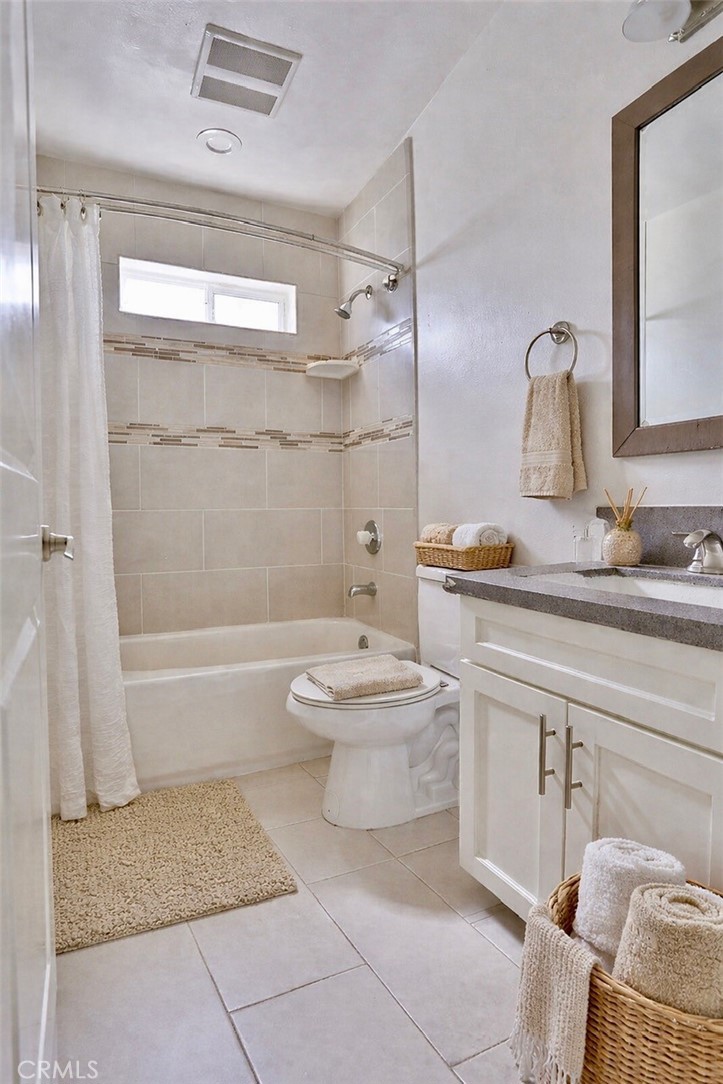 12500 Wilmington Avenue, Unit A Compton, CA 90222 - Photo 3 of 8 a bathroom with a sink a toilet and shower