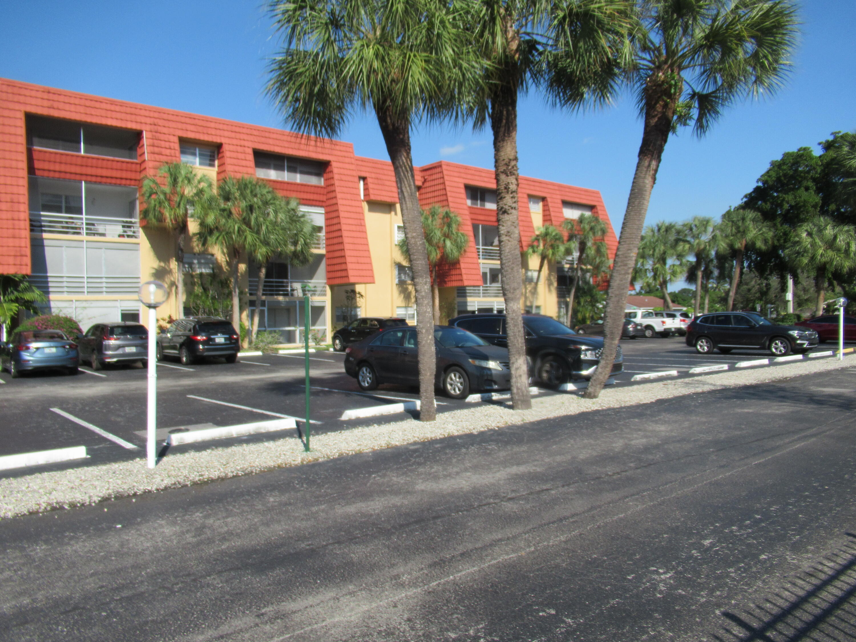 22605 Southwest 66th Avenue, Unit 410 Boca Raton, FL 33428 - Photo 22 of 28 a view of a street with a building in the background