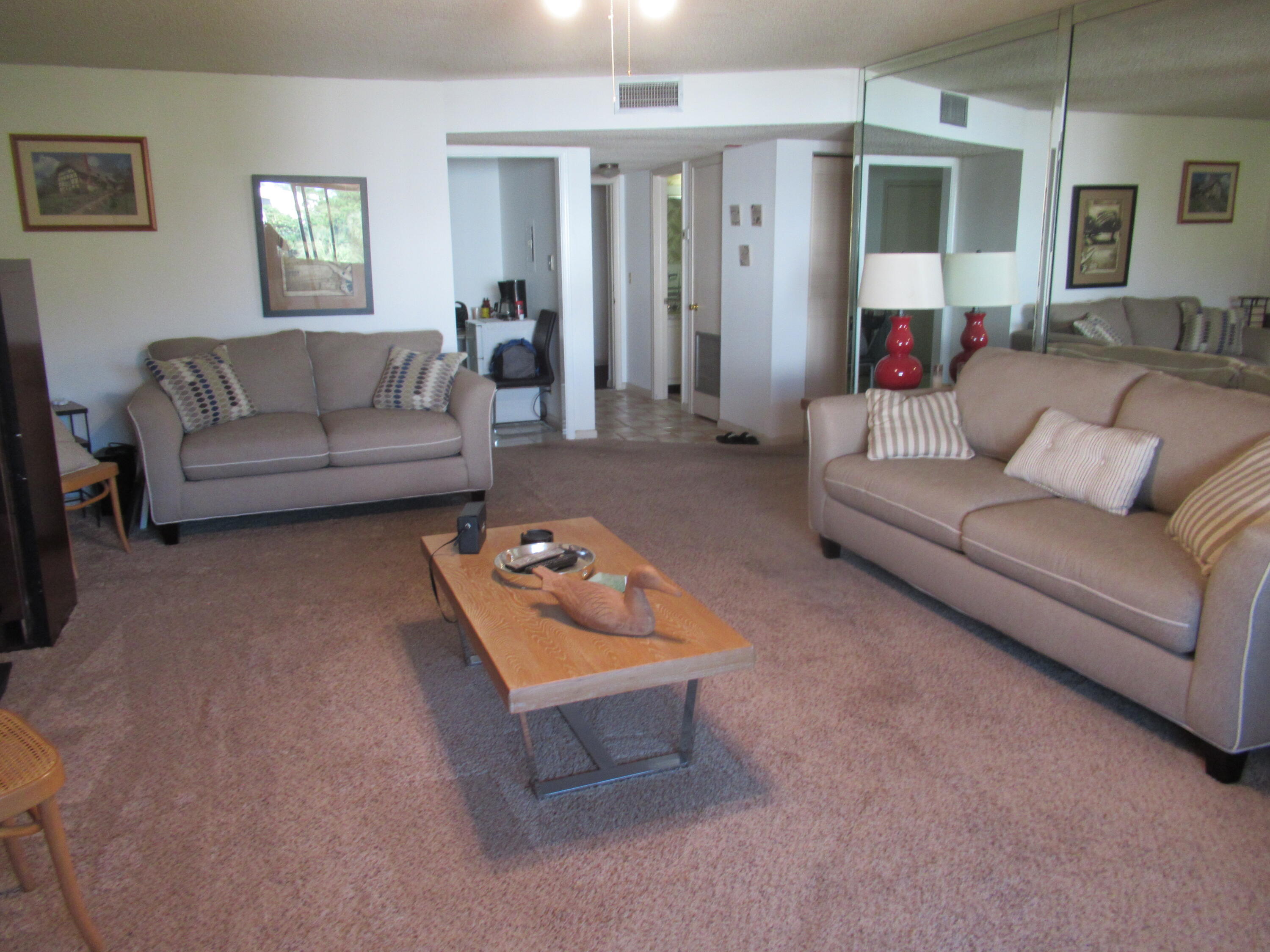 22605 Southwest 66th Avenue, Unit 410 Boca Raton, FL 33428 - Photo 6 of 28 a living room with furniture and a couch
