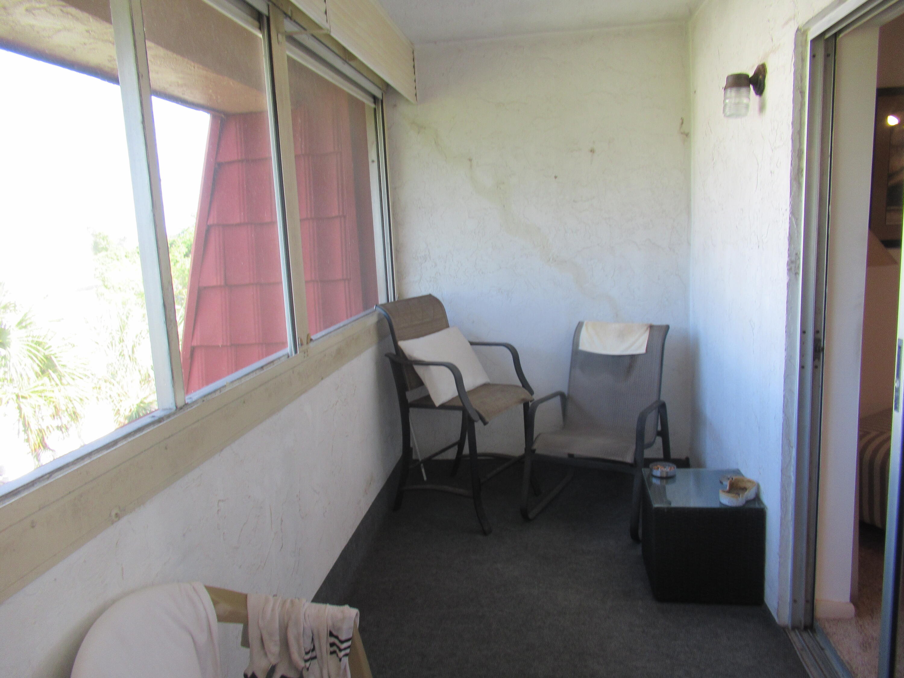 22605 Southwest 66th Avenue, Unit 410 Boca Raton, FL 33428 - Photo 9 of 28 a view of a hallway with chairs and a window