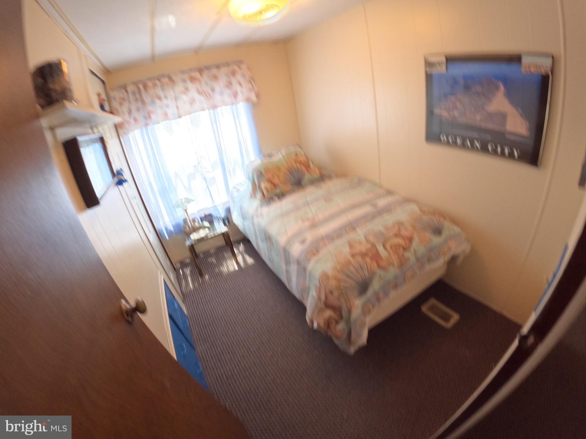 163 Clamshell Road Ocean City, MD 21842 - Photo 10 of 18 a bed sitting in a room next to a window