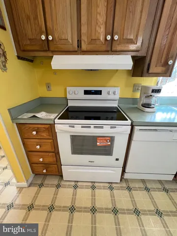 a stove top oven sitting inside of a kitchen