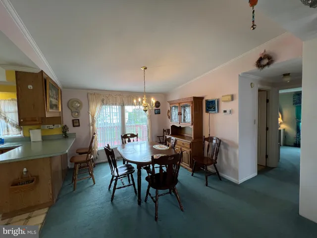 a view of a dining room with furniture and window