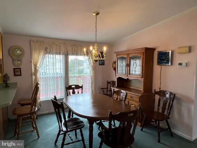 a view of a dining room with furniture and window