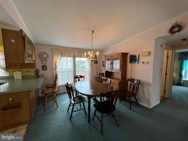 a view of a dining room with furniture and window