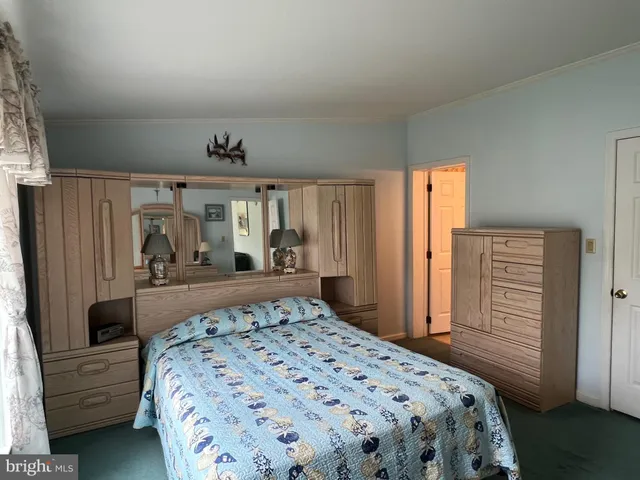 a bedroom with a large bed and a dresser