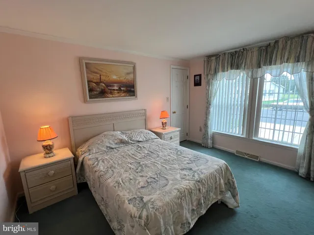 a bedroom with bed and window