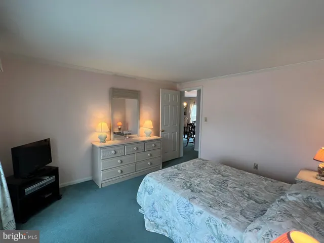 a bedroom with a bed and a television