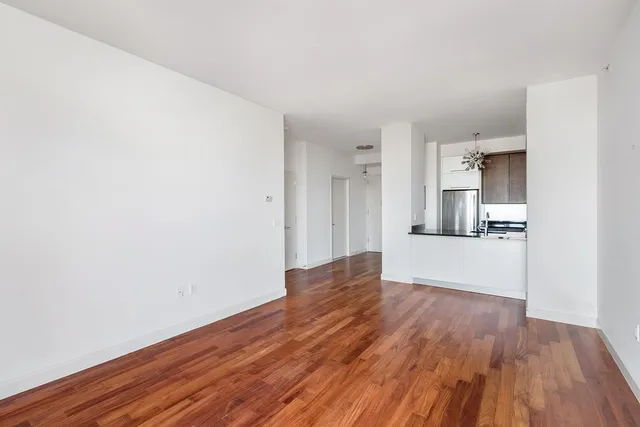 a kitchen with granite countertop a stove a sink and a microwave