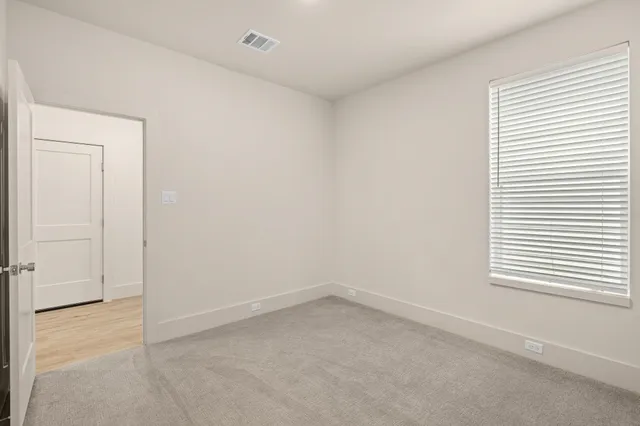 a living room with furniture and a view of kitchen
